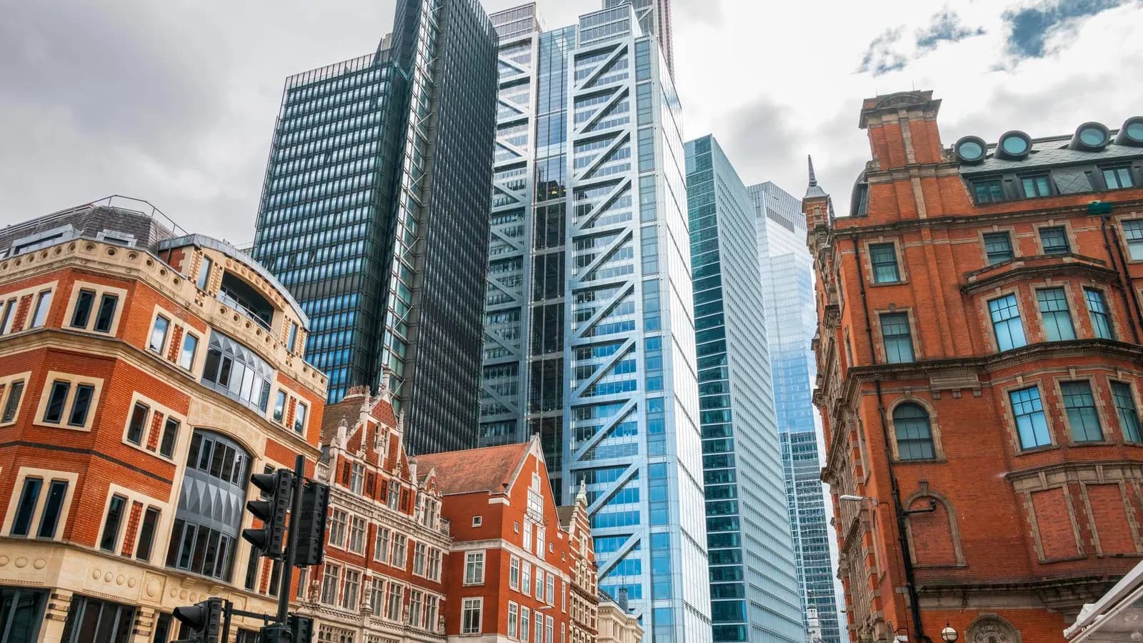 Red-brick Victorian buildings in front of glass office towers in the City of London
